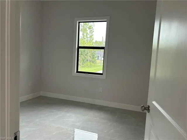 Tiled spare room with plenty of natural light