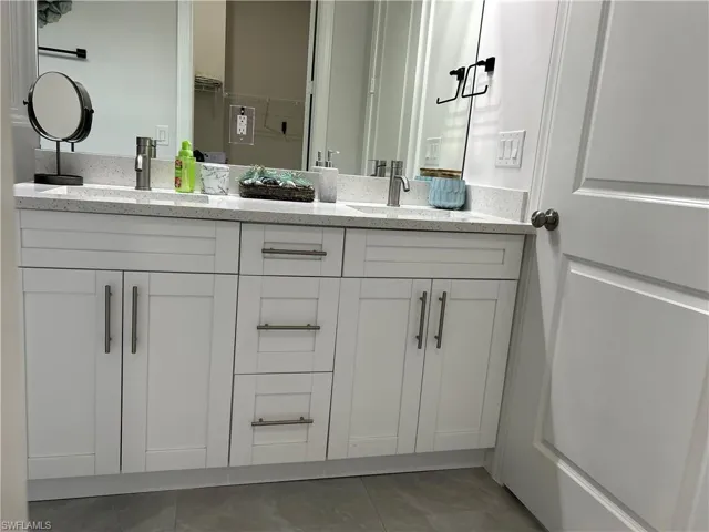 Bathroom with tile patterned flooring and vanity