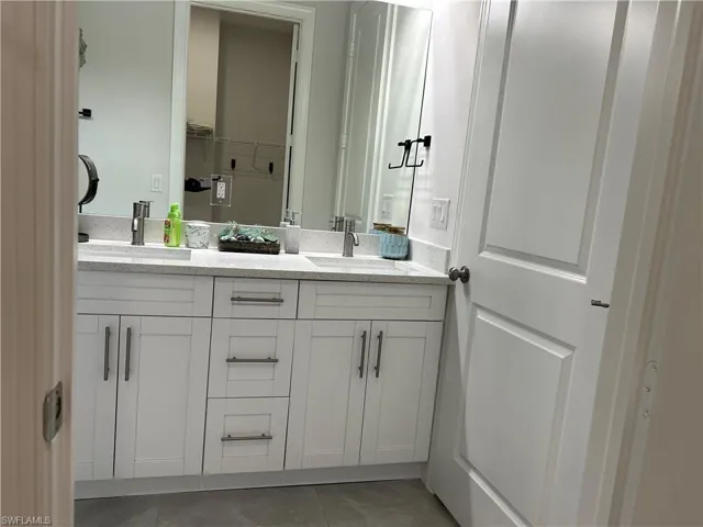 Bathroom with tile patterned floors and vanity