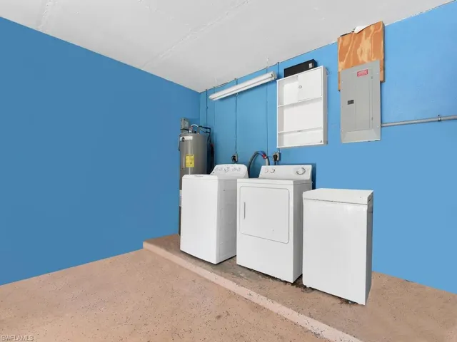 Clothes washing area with electric panel, washer and dryer, and laundry area