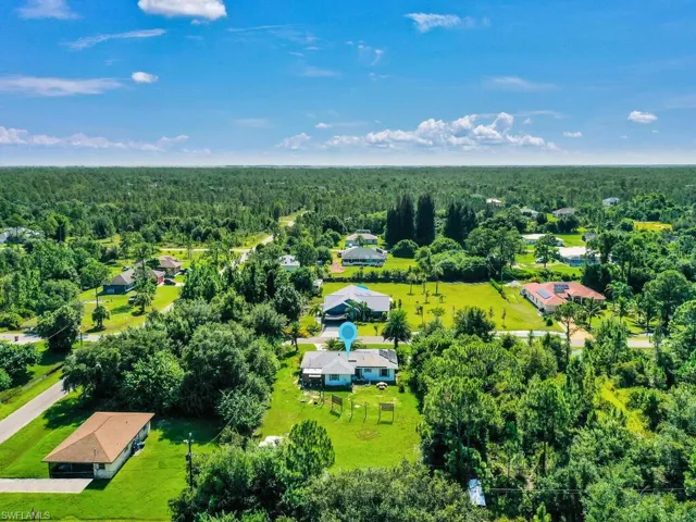 Aerial view featuring a view of trees