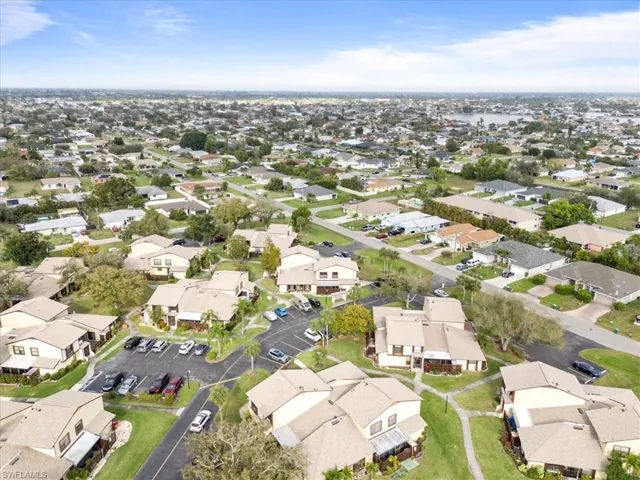 Aerial view of property and surrounding area with nearby suburban area