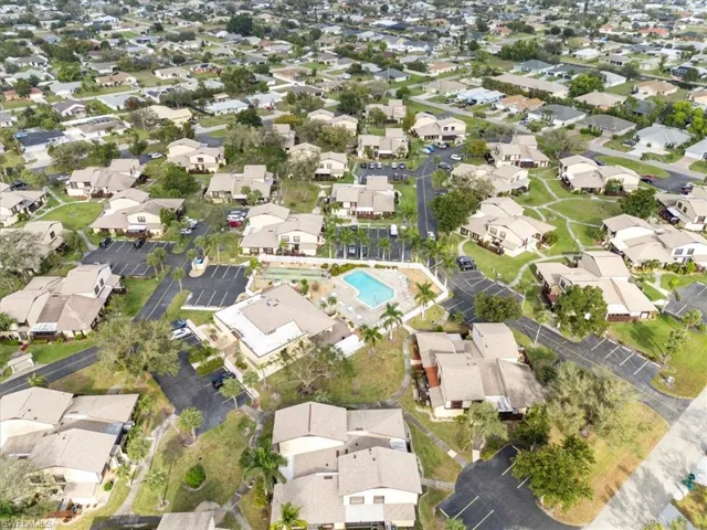 Aerial view of property's location with nearby suburban area and a pool