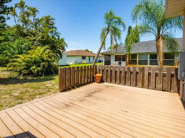 Expansive outdoor deck featuring wood-finish composite decking and a privacy fence