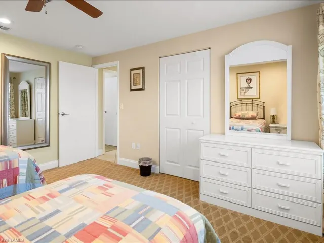 Light-toned walls complement the neutral patterned carpet
