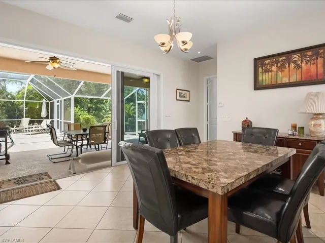 Screened patio with a ceiling fan, accessible via wide sliding glass doors