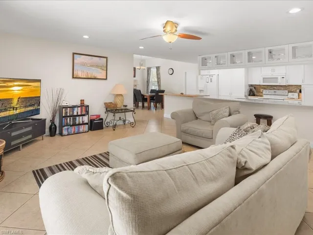 Open-concept living space featuring neutral-toned tile flooring throughout
