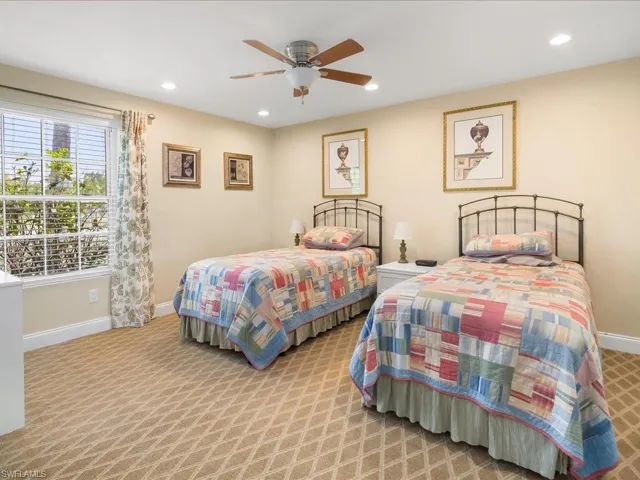 Bedroom with patterned carpeting, recessed lighting, and a ceiling fan
