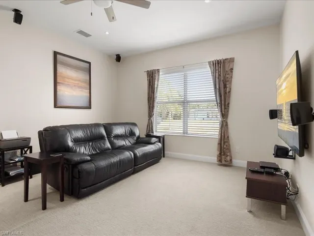 Carpeted room featuring a ceiling fan, recessed lighting, and window blinds with curtains