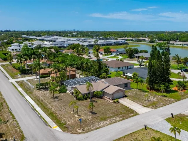 Aerial perspective showcasing a residential street with an available lot