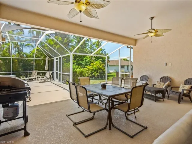 Screened lanai featuring textured concrete flooring and stucco walls