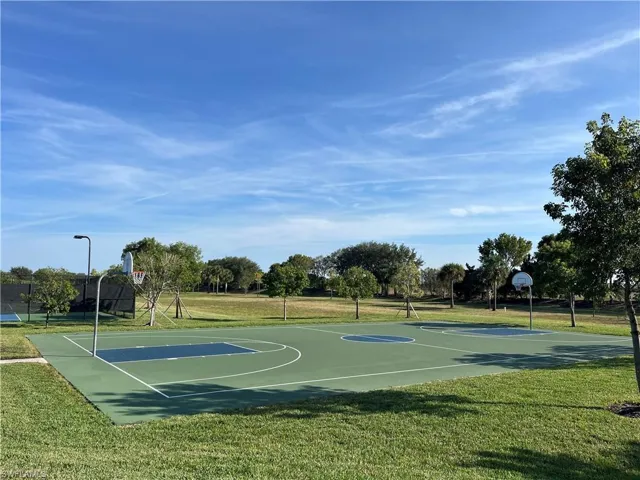 View of sport court with a yard and community basketball court