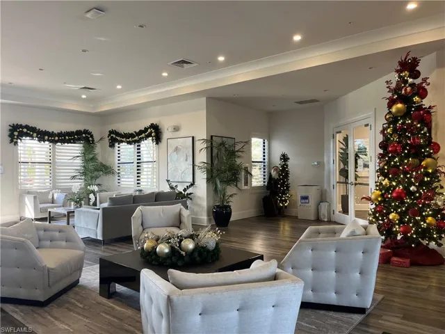 Living room with recessed lighting, dark wood finished floors, french doors, and a raised ceiling