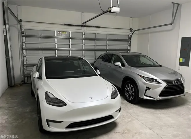Garage with electric panel and a garage door opener