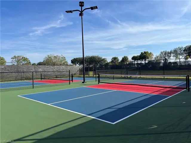 View of tennis court with community basketball court