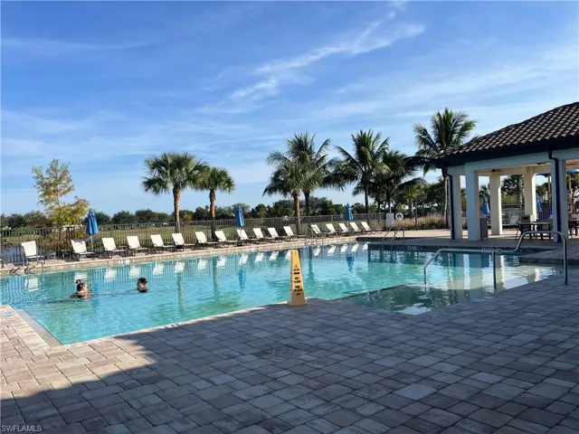 Community pool with a patio