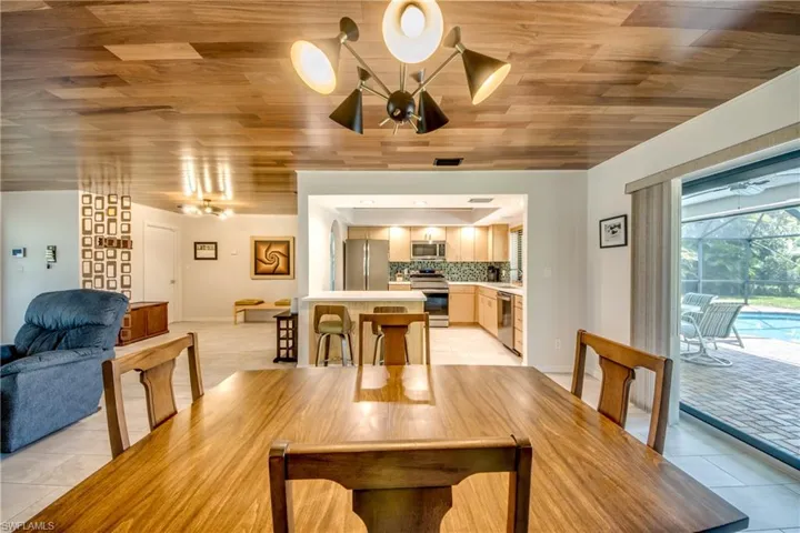 Dining space featuring wooden ceiling, a chandelier, and light tile patterned floors