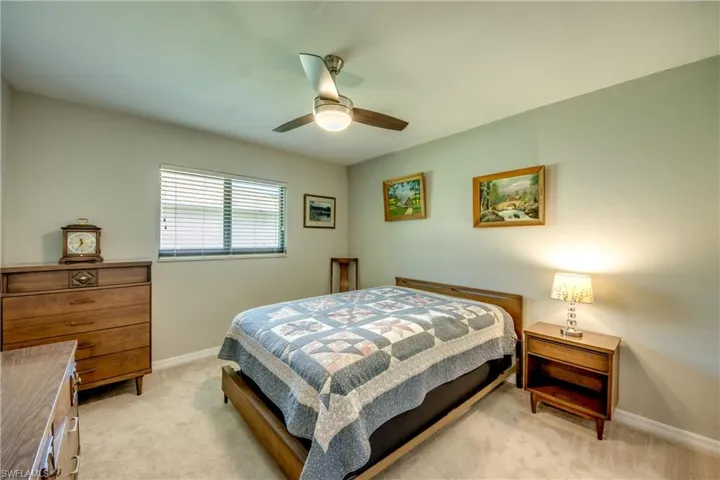 Bedroom featuring ceiling fan and light carpet