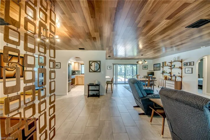 Living room featuring wooden ceiling and light tile patterned flooring
