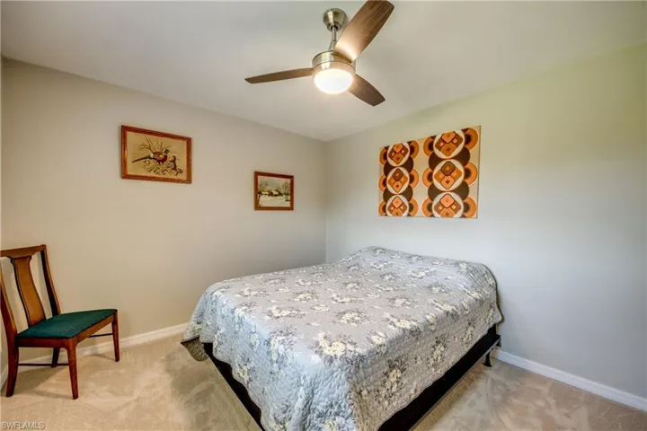 Bedroom featuring light colored carpet and ceiling fan
