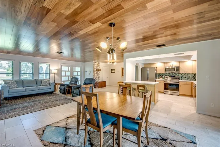 Dining room featuring wood ceiling, a notable chandelier, and light tile patterned floors
