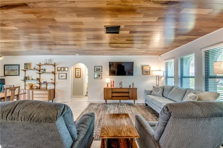 Tiled living room featuring wood ceiling