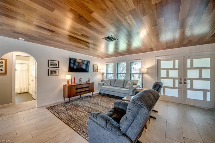 Living room featuring wood ceiling and french doors