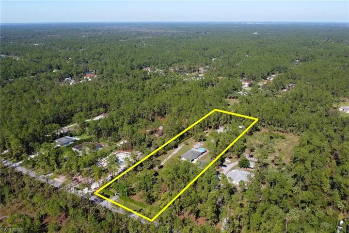 Look how spacious this 2.73 Acre lot is! Long paved driveway plus an additional driveway that leads you to the back of the lot that is fully cleared! Calusa privacy shrubs and fencing throughout the lot for added privacy!