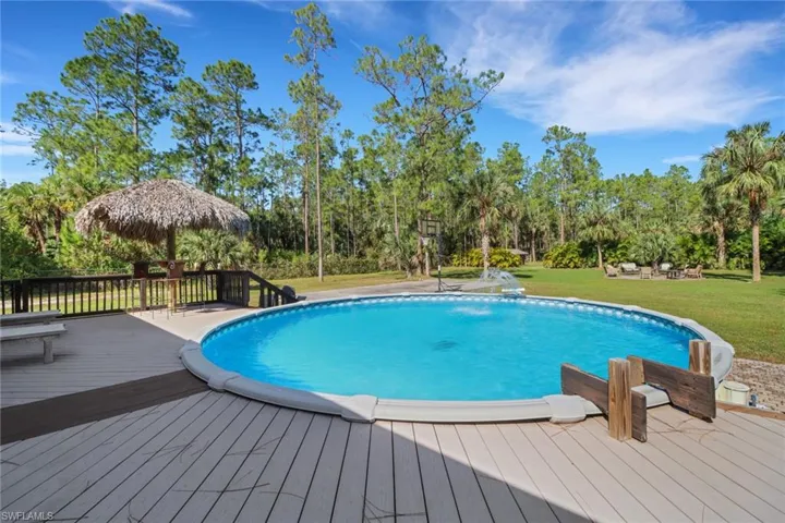 Beautiful pool with new solid composite decking that is durable, low maintenance, resistant to moisture, insects, and stains, and environmentally friendly. Concrete basketball court, fire pit, swing set, chicken coop, and a large covered area for an RV, also a large cleared area in the back to park all your work trucks, toys, etc. Property has been cleared for a 40x60 workshop
