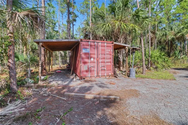 Shipping Container with Extended roof. Great space to store work materials.