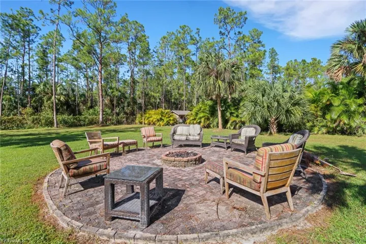 Firepit area that is spacious and private! Make smores, enjoy a glass of wine on our cool FL nights by the fire! Behind the Calusa Shrubs is a fully cleared space to park your work trucks/RV/Boat. There is a cleared and filled space that was done for a 40x60 workshop