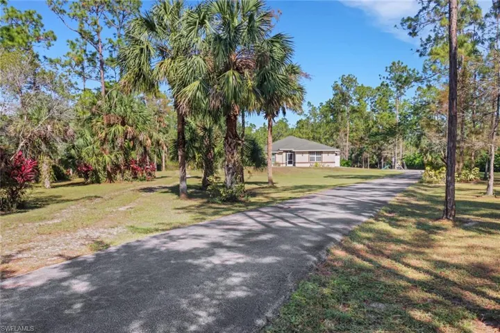 Long Paved Driveway with attached two car garage, basketball court, playground, firepit, cleared area in the back for a 40x60 workshop and so much more