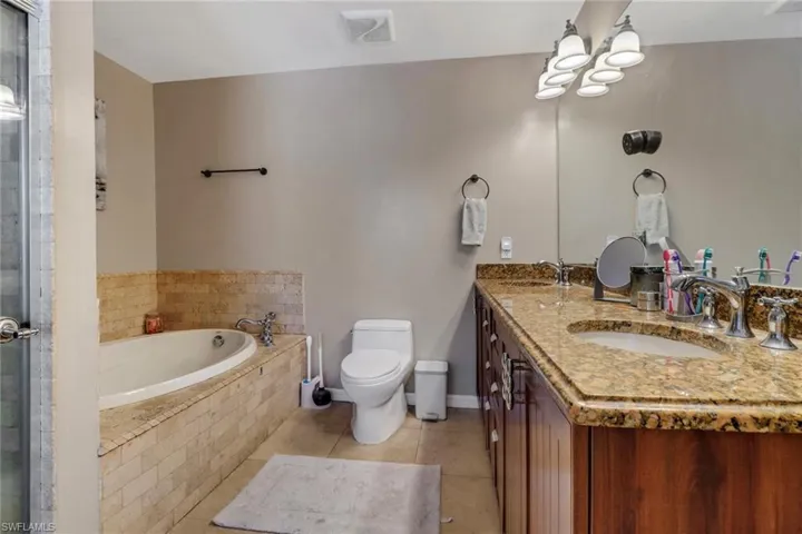 Another view of the master bathroom with large soaking tub, separate shower, and large vanity with ample counter space to get ready
