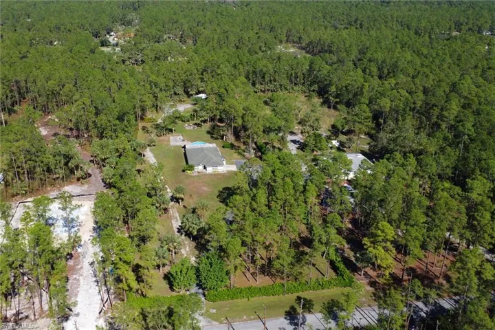 This shows you the large 2.73 Acre lot with additional driveway to the back of the lot that is fully cleared and ready for a guest house or workshop to be built! Home is set back with a long paved driveway and privacy shrubs/fencing throughout. New Gated Entry for additional security.