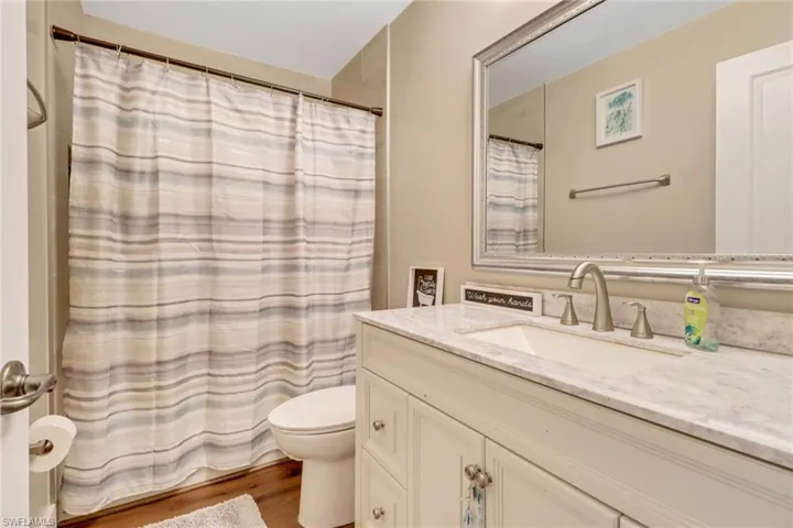 Guest Bath with new vanity, mirror, and a tub/shower combo