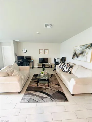 Living room with light tile patterned floors