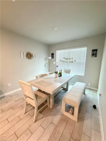 Dining room with wood tiled floors and baseboards