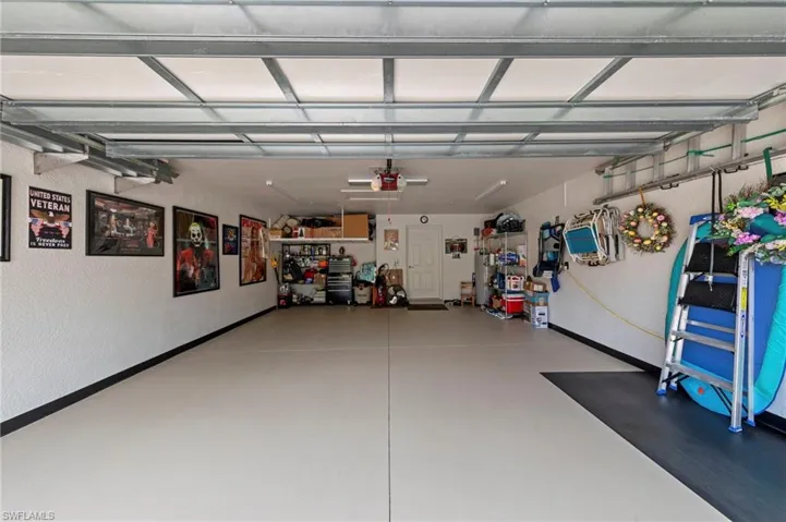 Epoxy-coated flooring with accent border, overhead garage door track system, and a side entry door