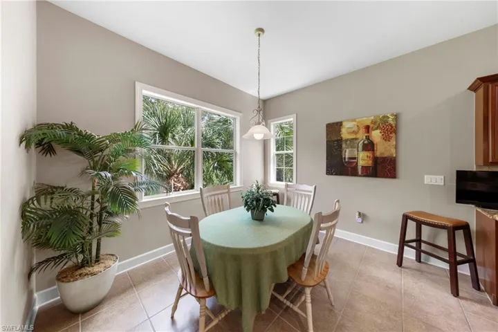 Tile flooring and multiple windows with white trim