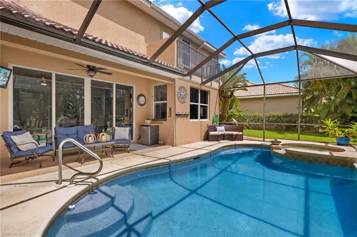 Integrated pool / hot tub featuring an outdoor living space, a lanai, a sunroom, and a patio area