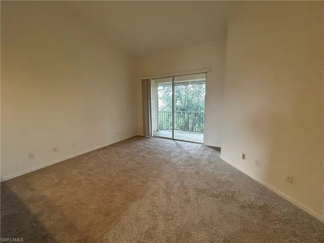 Unfurnished room featuring carpet and baseboards