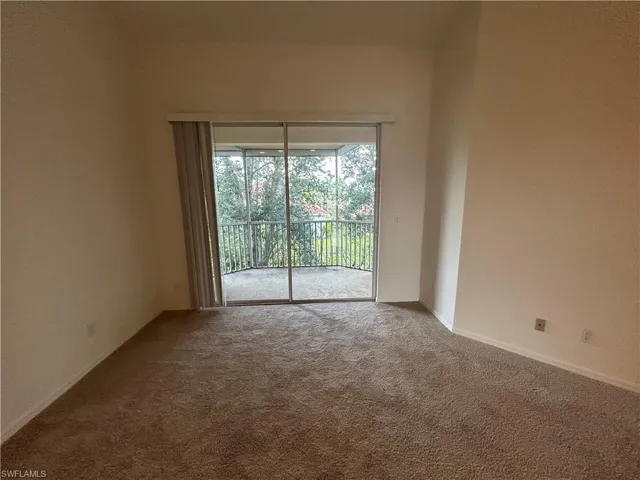 Carpeted spare room with baseboards