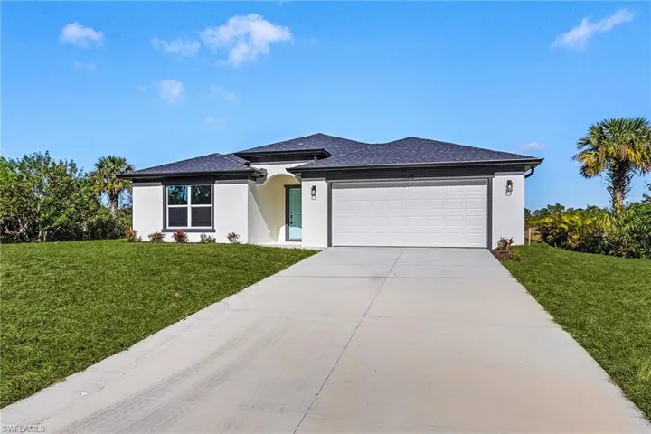 View of front of house featuring a garage and a front yard