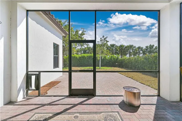 Unfurnished sunroom featuring a patio area