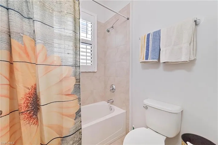 Bathroom with toilet and shower / tub combo