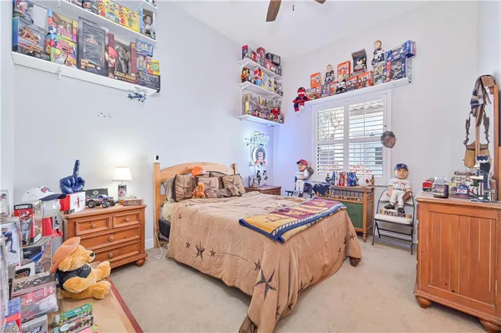 Bedroom with light colored carpet and ceiling fan