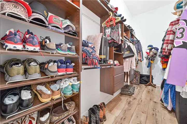 Walk in closet featuring light wood finished floors
