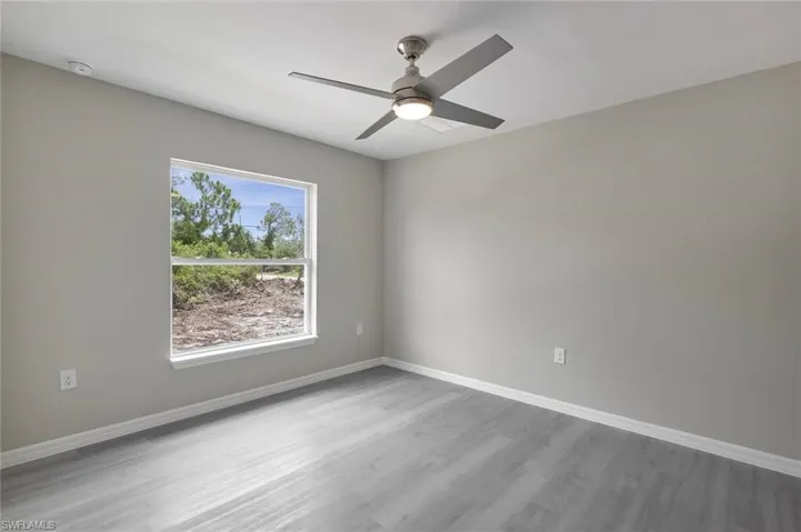 Spare room featuring ceiling fan and light wood-type flooring