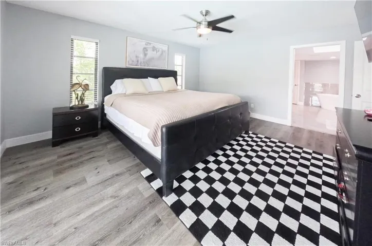 Bedroom, ensuite bath, and ceiling fan