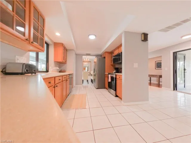 Kitchen featuring appliances with stainless steel finishes, light tile patterned floors, and sink
